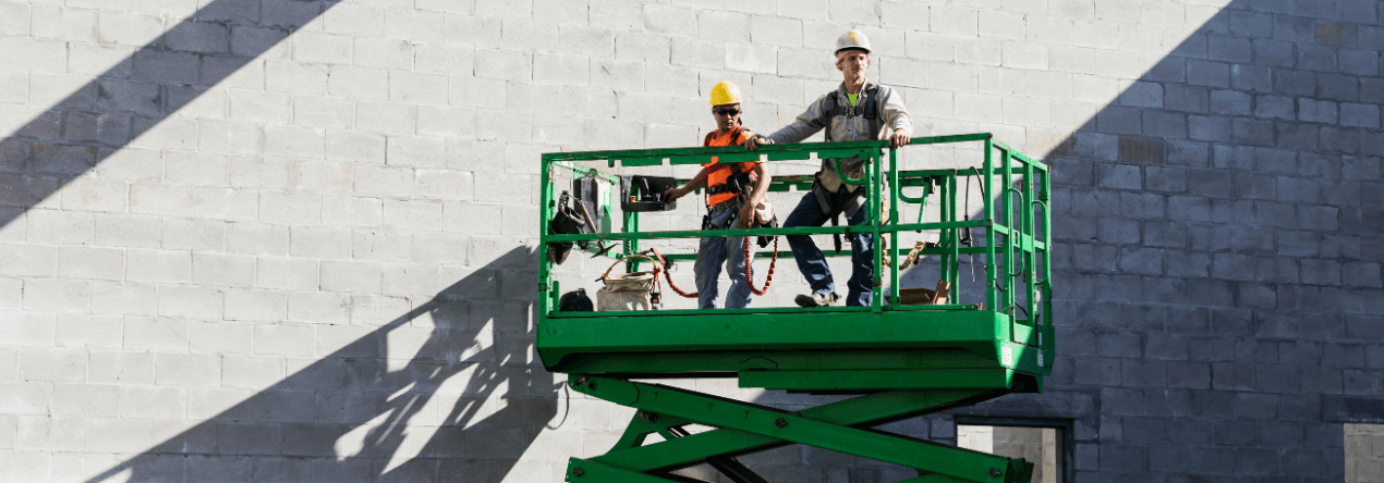 two workers using a scissor lift