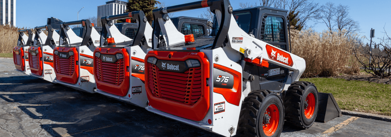 bobcat skid steers parked and lined up